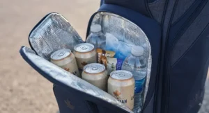 Interior view of an insulated golf bag cooler compartment packed with refreshments for a round of golf.