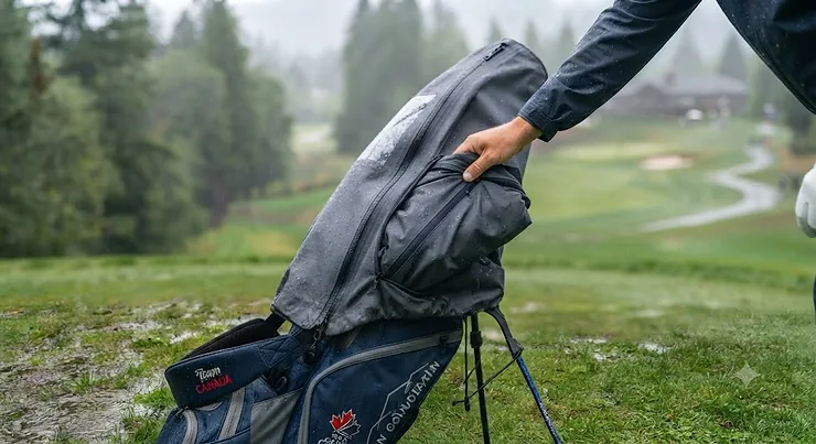 A waterproof golf bag rain cover for stand bags fitted securely on a golf bag during a rainy round in Canada.