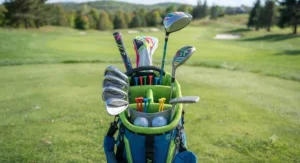 Top-down view of a well-organized lightweight junior golf bag for kids featuring protective club dividers and golf tees.