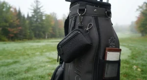 Durable, weather-resistant golf valuables pouch with key clip hanging on a golf bag ready for Canadian weather.